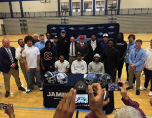 Ten James Clemens football players sign for scholarships