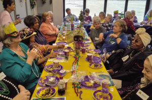 Rotary Club fetes Madison Senior Center members with Mardi Gras bash